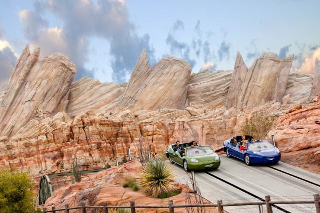 Riders speed through the desert landscape of Radiator Springs Racers at Disney California Adventure Park. The attraction’s racecars zoom past towering rock formations inspired by Route 66 and Pixar's Cars.